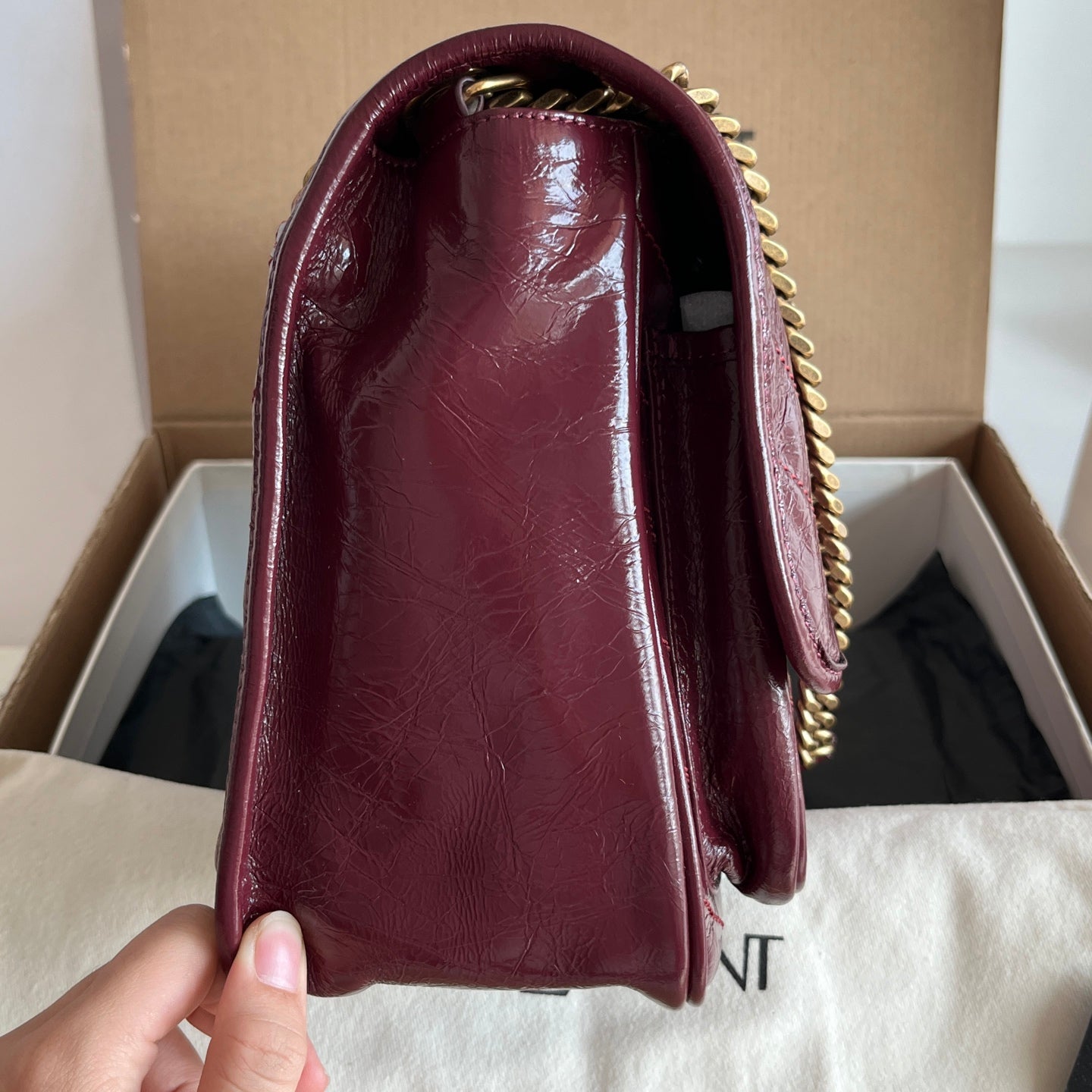 Saint Laurent burgundy leather shoulder bag front view with gold chain detail