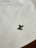 Louis Vuitton long jacket fabric close-up with small LV logo patch
