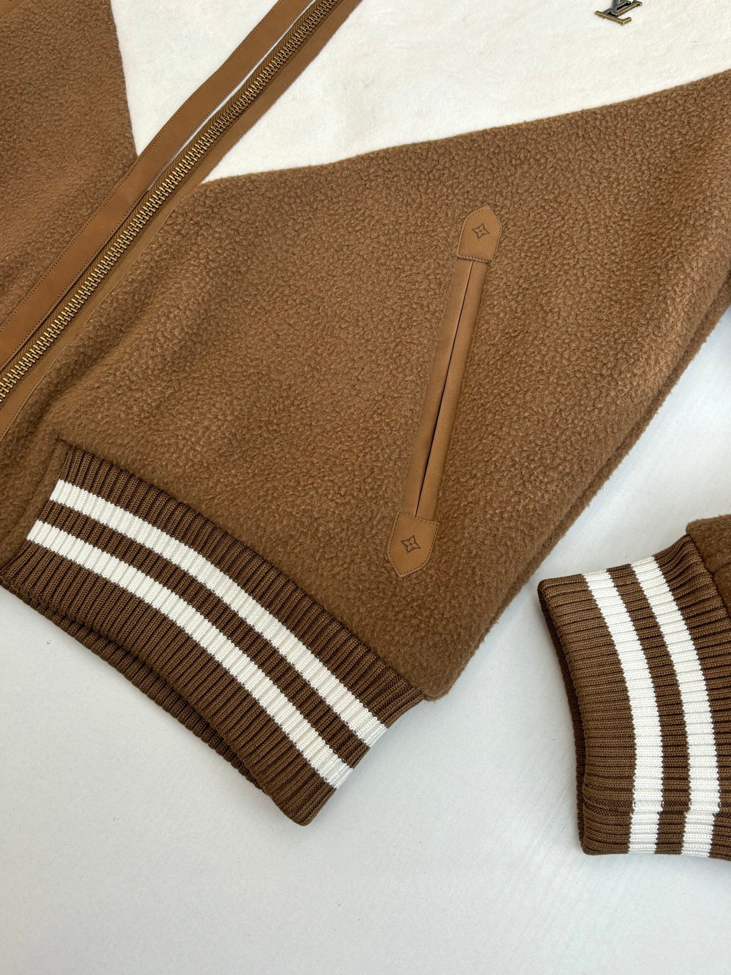 Louis Vuitton long jacket sleeve and stripe cuff with front zip and leather logo patch