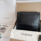 YSL bag in black textured leather with flap and silver chain strap, front view