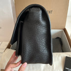 YSL bag side view with black textured leather and curved opening, smooth black lining