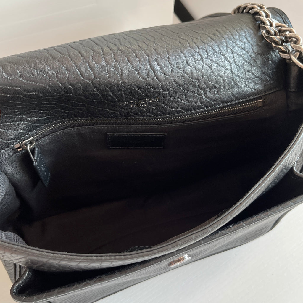 YSL bag interior view: black leather lining with zipper pocket, silver chain hardware