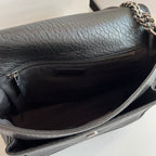 YSL bag interior view: black leather lining with zipper pocket, silver chain hardware