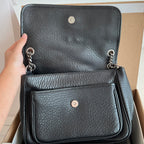 YSL bag with two front flaps: top flap and pocket with snap, black textured leather