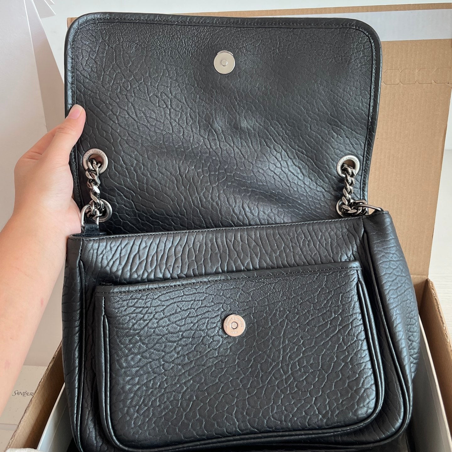YSL bag with two front flaps: top flap and pocket with snap, black textured leather