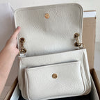 YSL bag in white textured leather with gold-tone hardware and dual front pockets