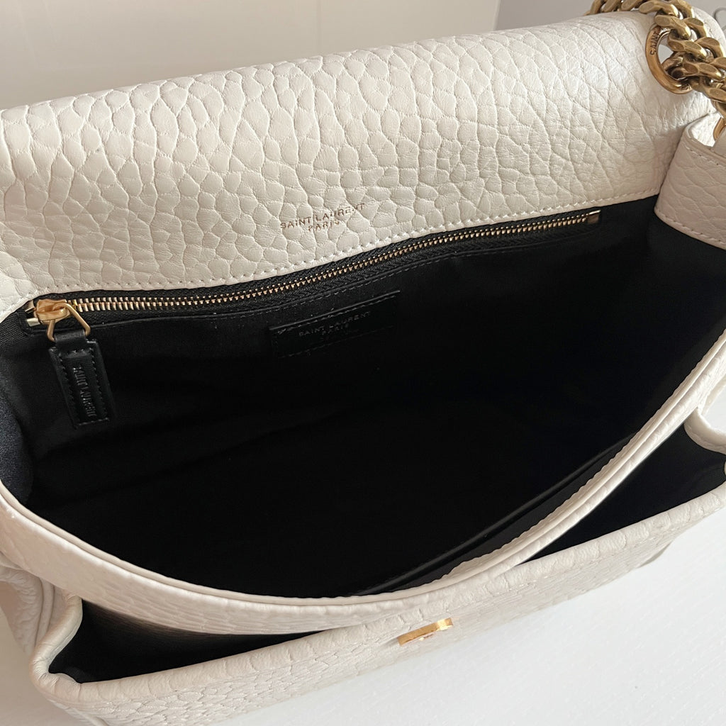 YSL bag open interior with black lining and zip pocket, white leather edges