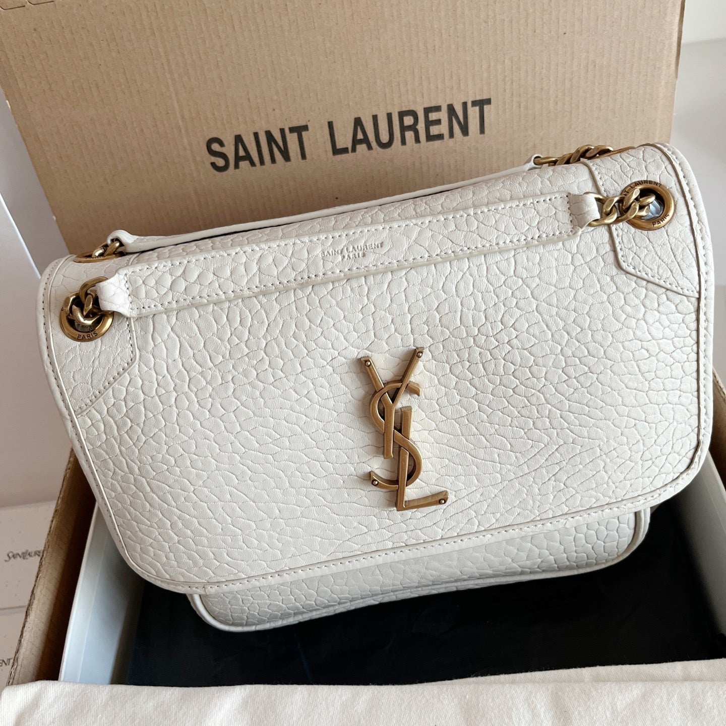 YSL bag in white textured leather with front flap, gold-tone chain hardware, YSL logo