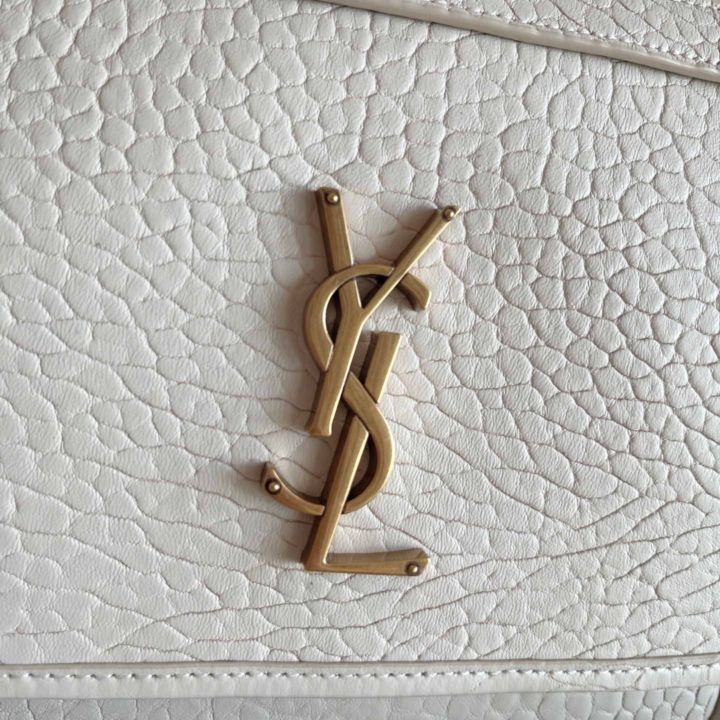 YSL bag front YSL logo in gold-tone on white textured leather