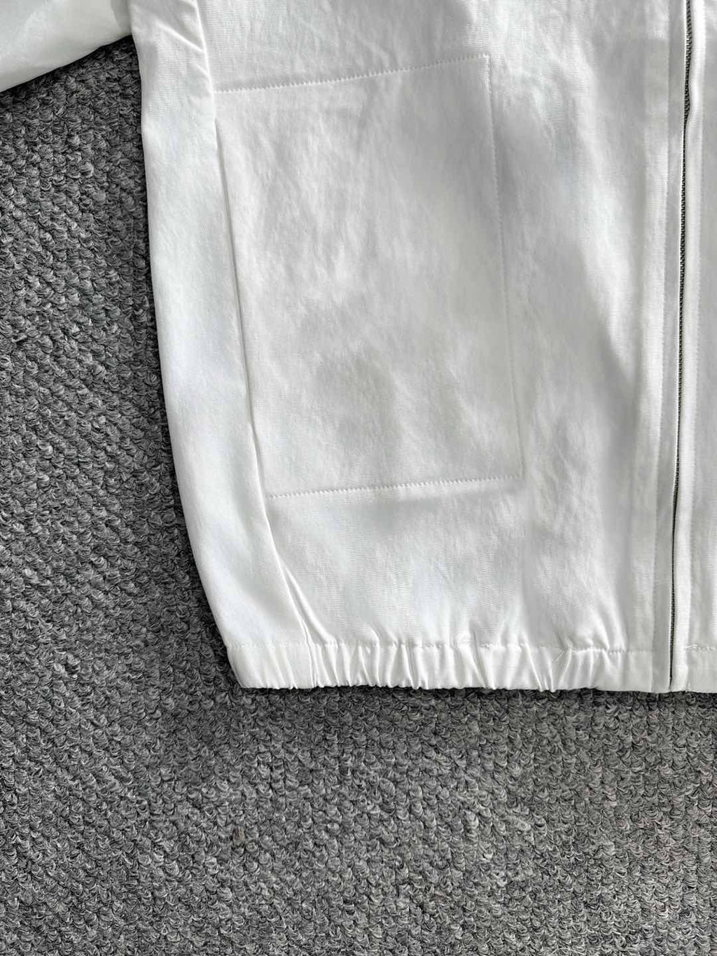 White jacket front panel with zipper and elastic hem