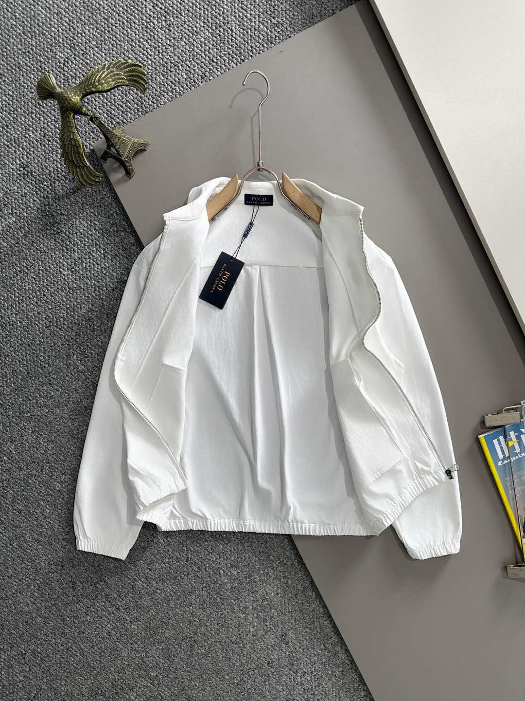 White zip jacket on hanger, long sleeves, Polo logo