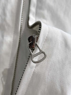 White jacket zipper with metal pull and stitched edge