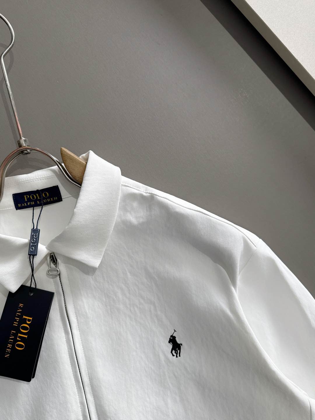 White zip jacket with small black Polo horse logo