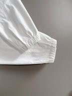 White jacket cuff with elastic hem and seam detail