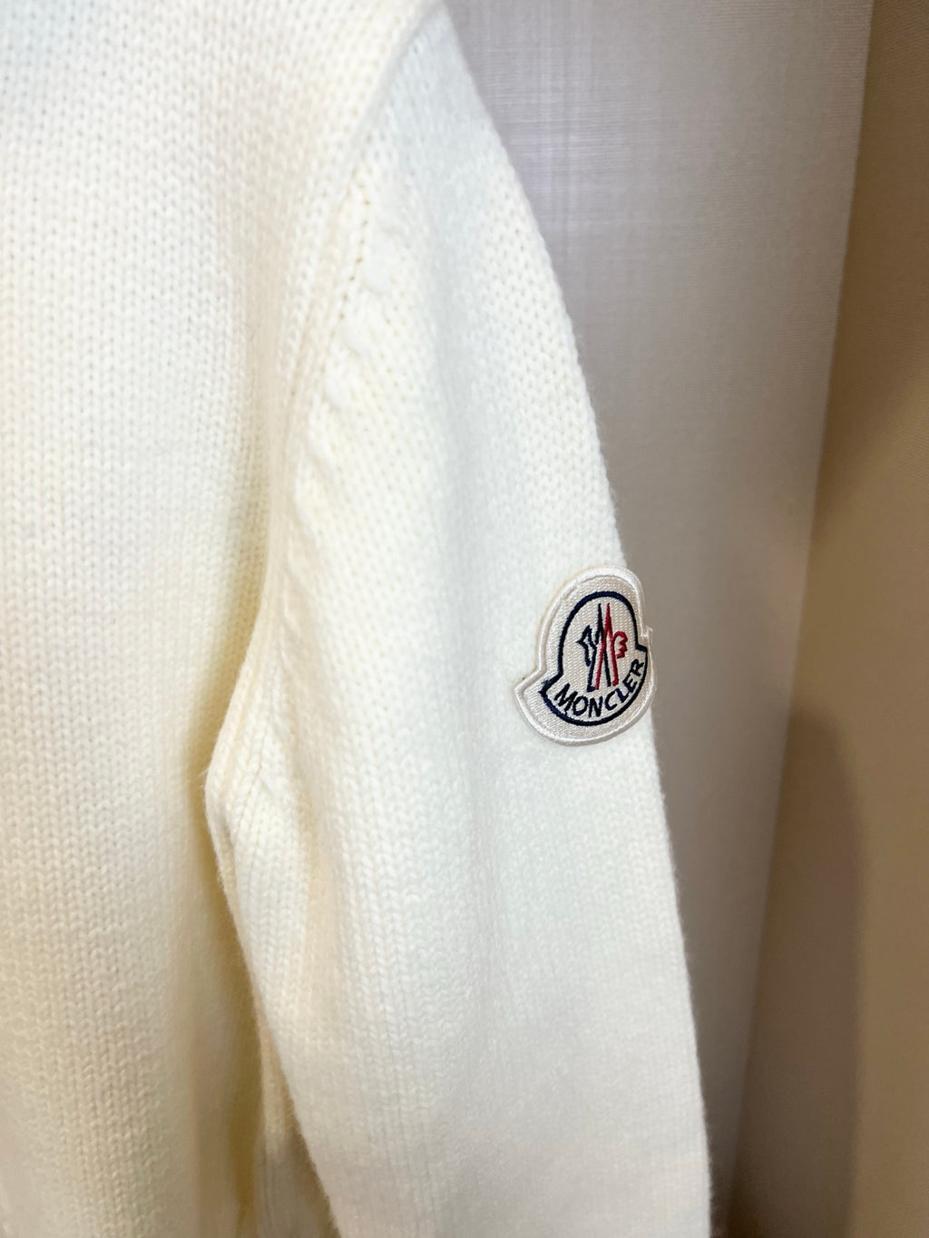 Moncler white knit sweater sleeve with Moncler logo patch