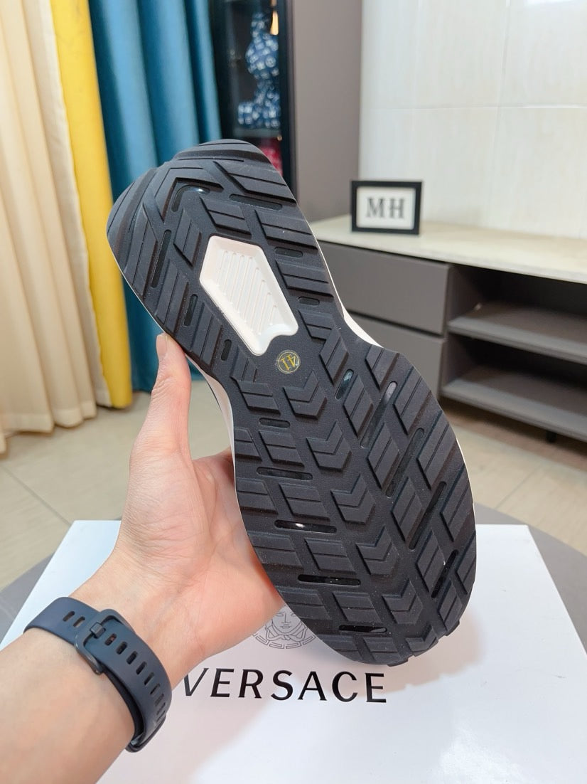Black sneaker outsole with textured tread, thick midsole and grip pattern.