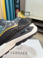 Black sneaker heel with gold accent and side panel detail; chunky white sole.