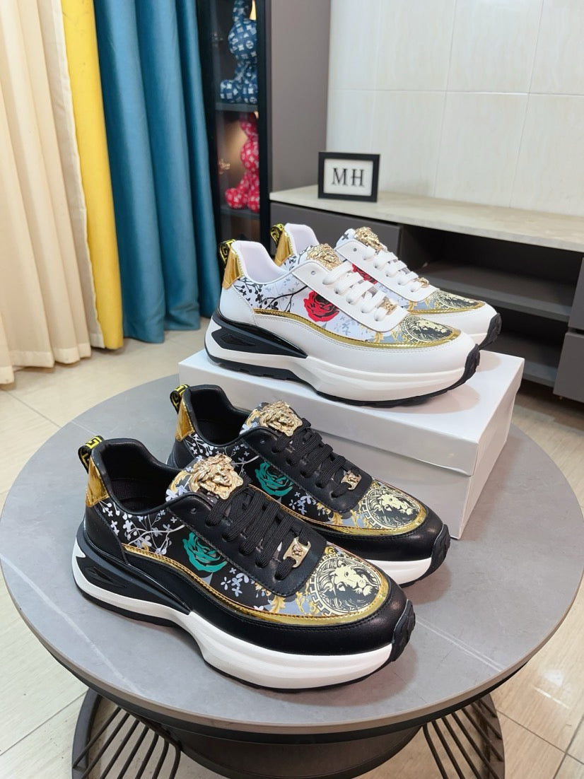 Black sneakers with gold trim, patterned uppers, lace-up front and chunky white sole.