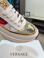Versace sneaker toe detail in white with gold crest graphic, white laces, thick sole