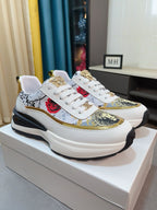 Versace sneakers on box, white upper with gold-trimmed graphic panel and lace-up