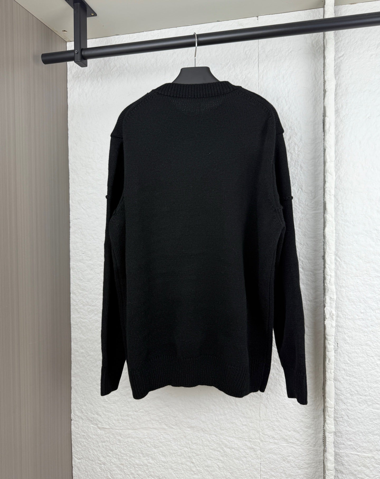 Dior long-sleeve knit sweater in black, back view with ribbed crew neckline