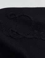 Dior black knit sweater with textured logo graphic on the chest