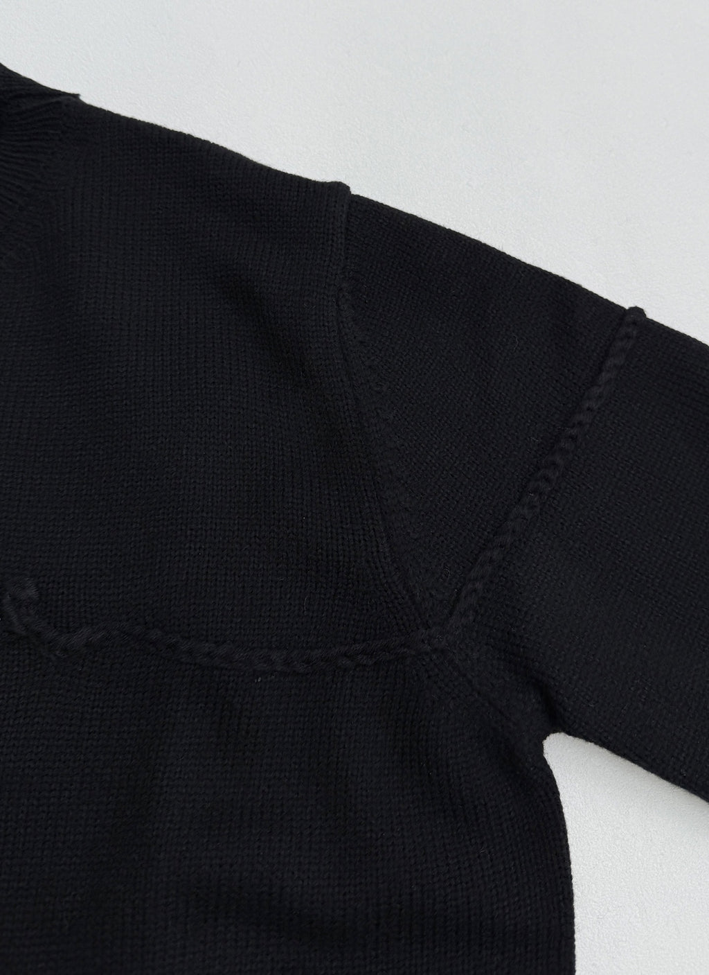 Dior black knit sweater shoulder and V-stitch seam near neckline