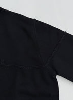 Dior black knit sweater shoulder and V-stitch seam near neckline