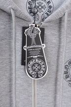 Grey zip hoodie with hanging tag labeled Comme des Garçons.