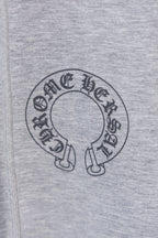 Grey hoodie fabric with circular logo graphic on the front.