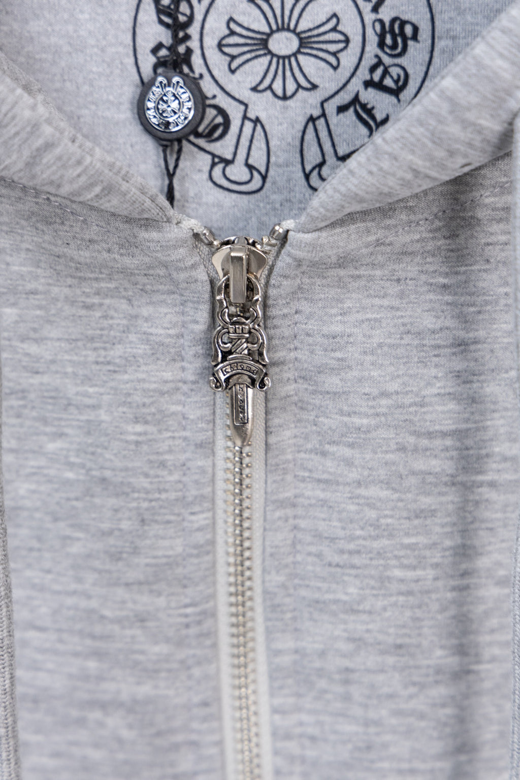 Grey zip hoodie with metal zipper and large chest logo graphic.