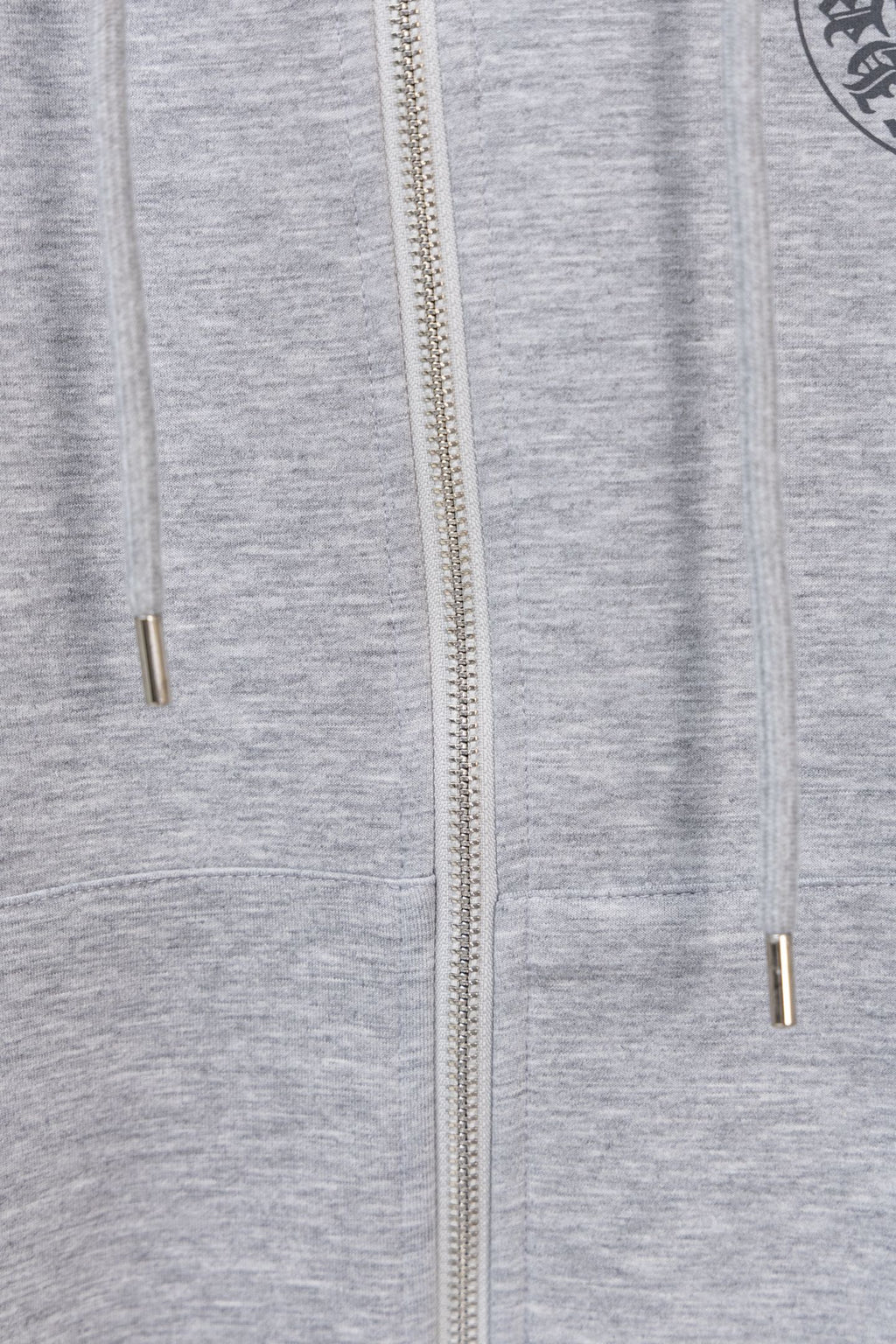 Grey zip hoodie with centered zipper and metal zipper pull at chest level.