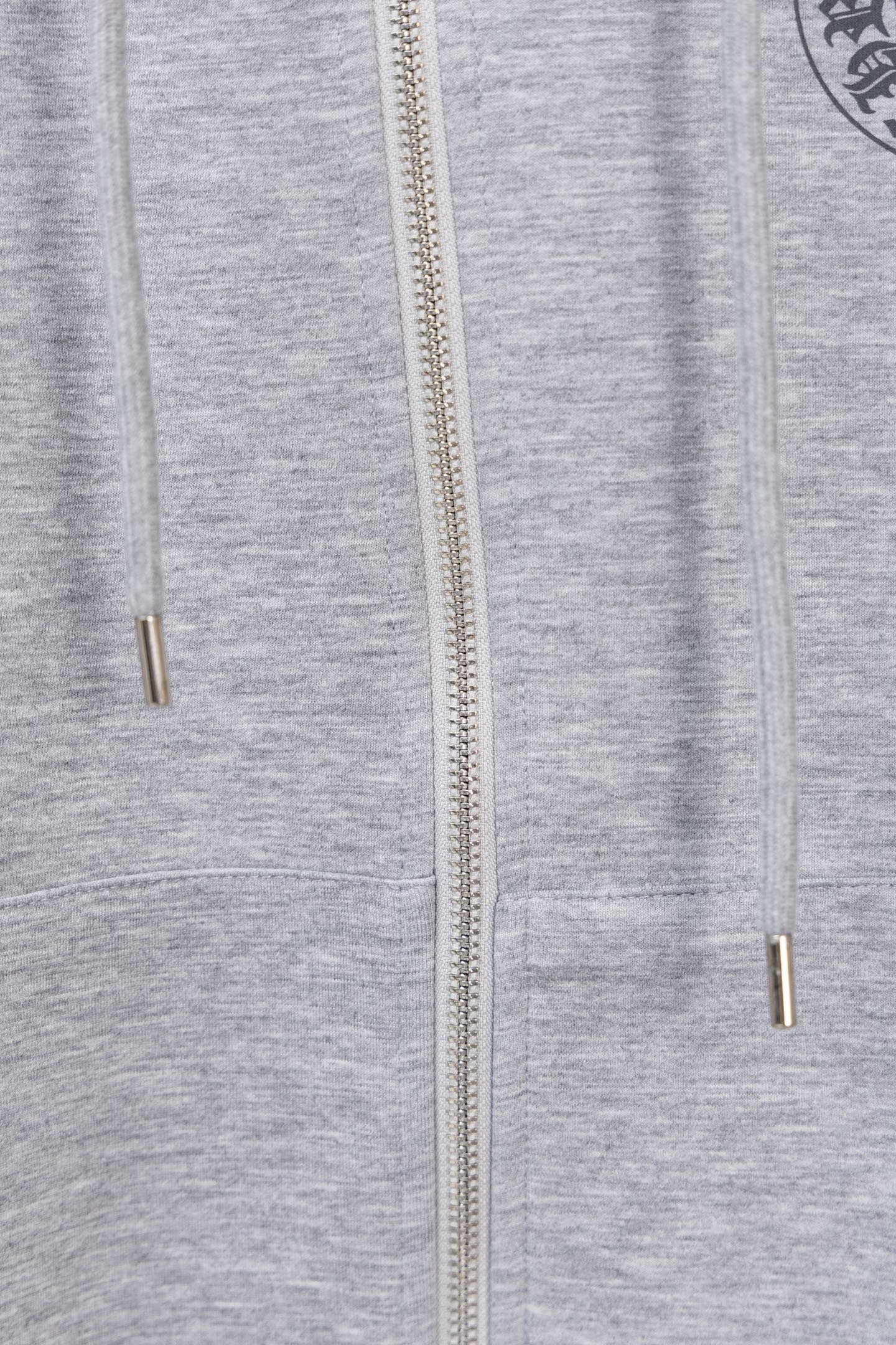 Grey zip hoodie with centered zipper and metal zipper pull at chest level.