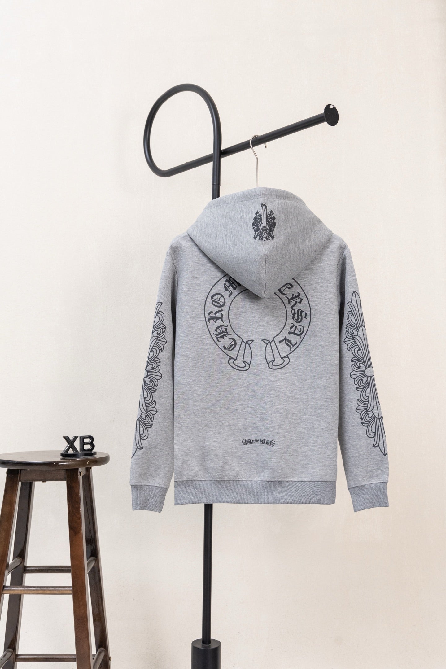 Grey long-sleeve zip hoodie with hood, back graphic, and graphic sleeve prints.