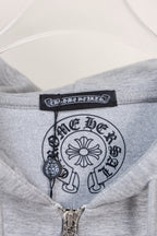 Grey hoodie collar with printed logo label and central zipper pull.