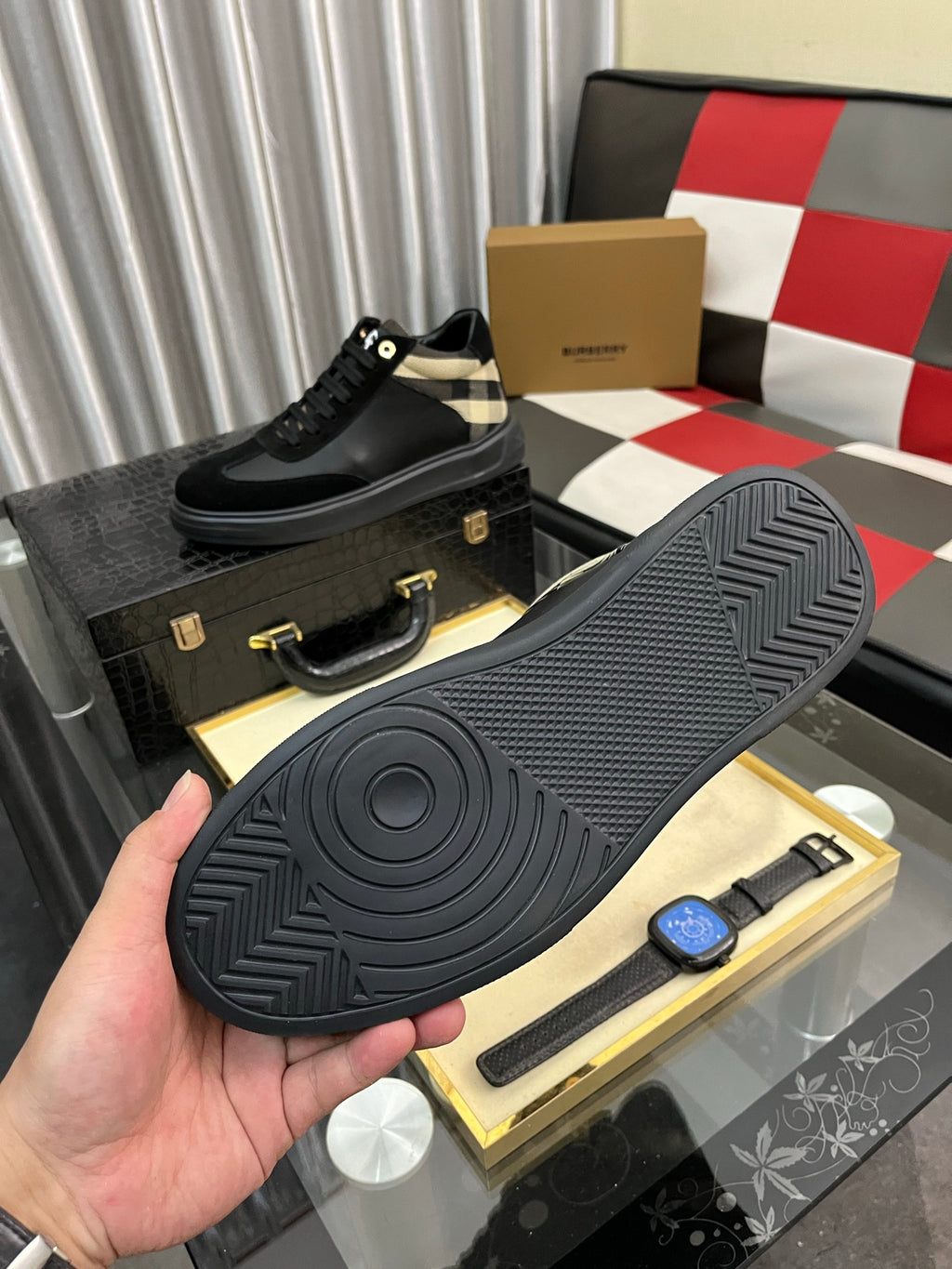 Black rubber outsole of low-top sneaker with textured tread and circular traction pattern