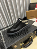 Black low-top sneaker with check-panel collar and black lace-up design