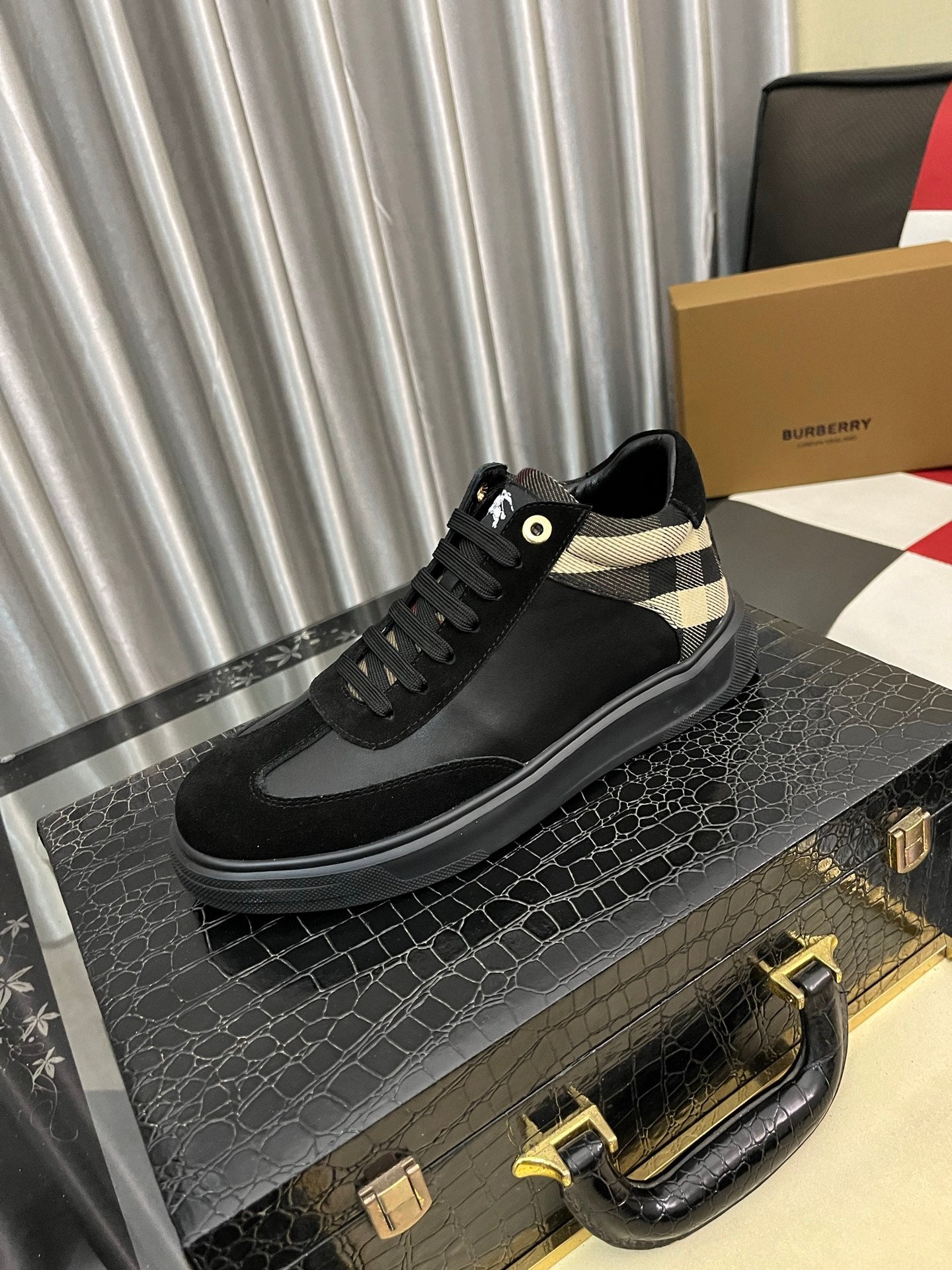Black low-top sneaker with check-panel collar and black lace-up design