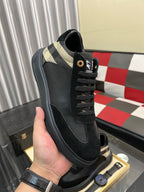 Black low-top sneaker with beige-and-black check collar and lace-up closure