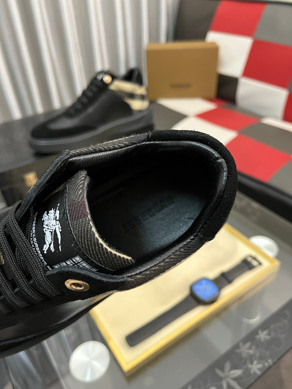 Inside view of black low-top sneaker showing fabric lining and lace eyelets