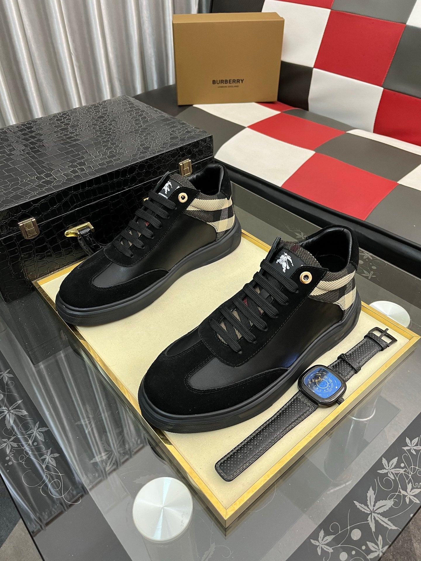 Pair of black low-top sneakers with beige-and-black check trim and lace-up fronts
