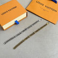 Gold-tone chain bracelet with Louis Vuitton logo charms and clasp