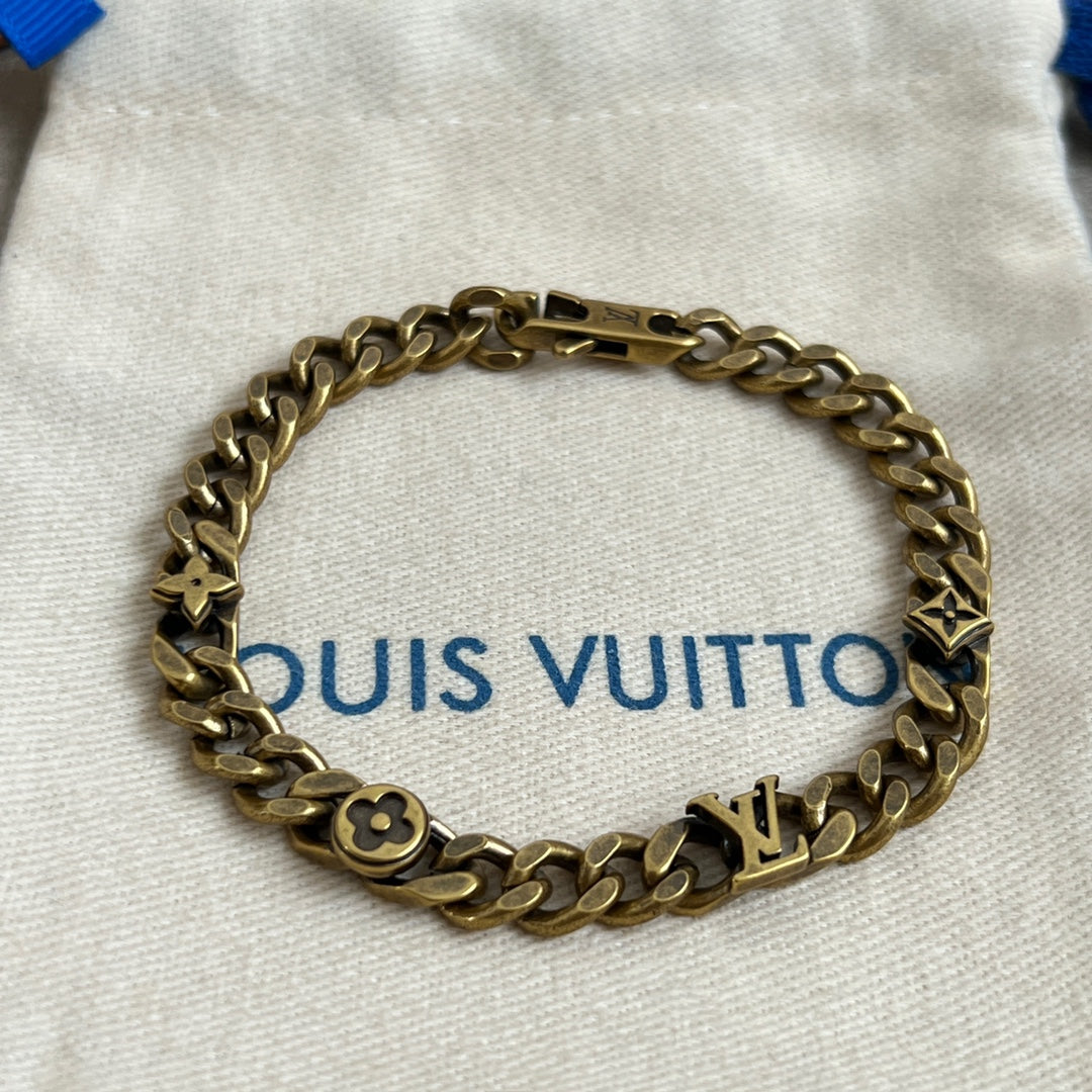 Gold-tone chain bracelet with monogram charms and small link details