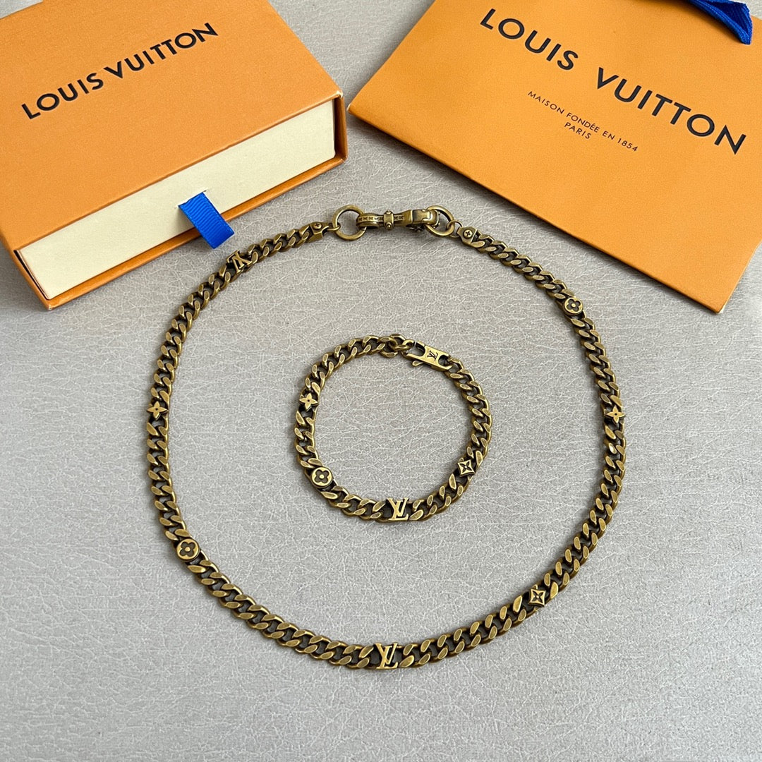 Gold-tone chain necklace with monogram charms and matching bracelet