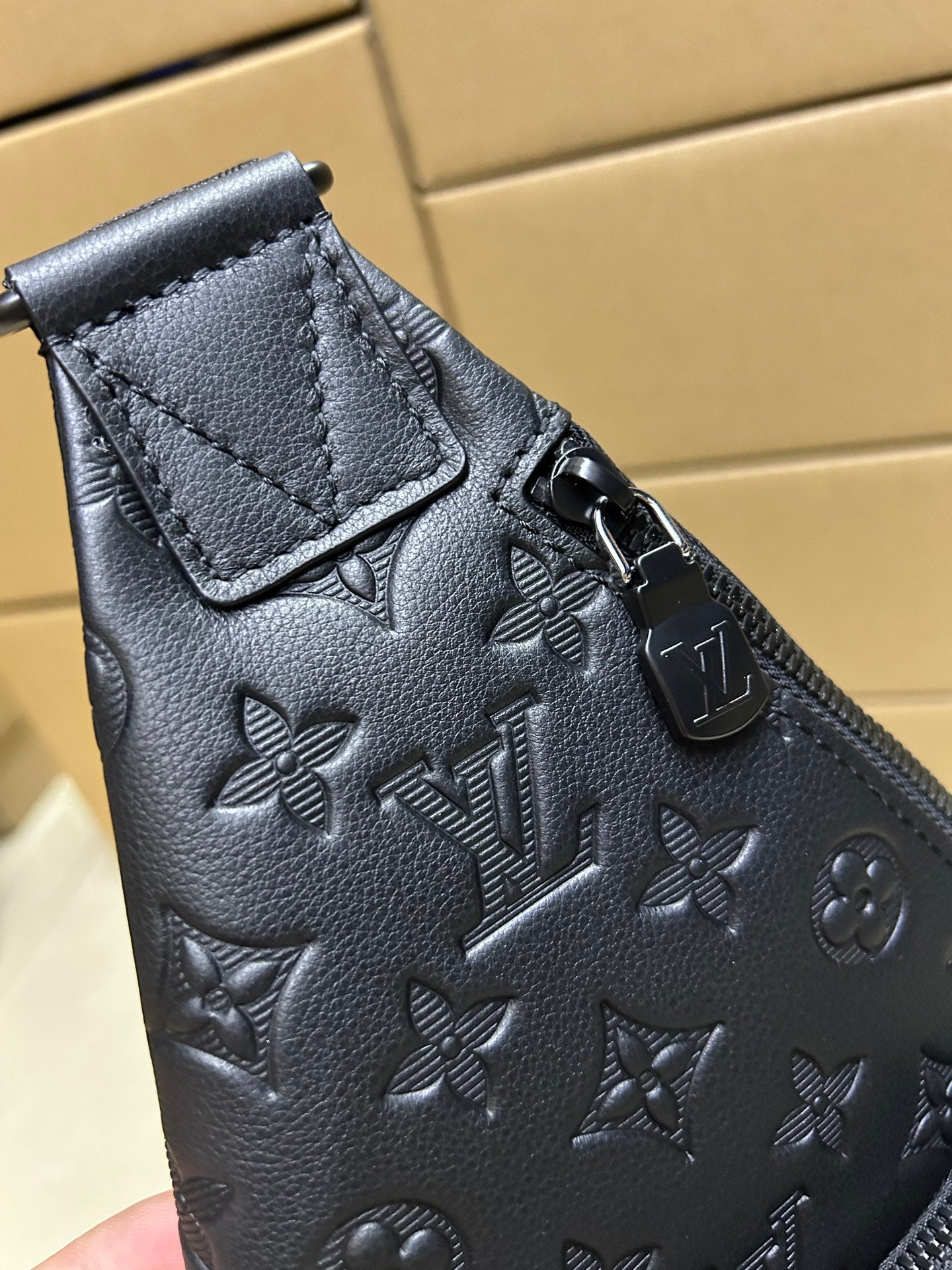Men's Louis Vuitton monogram leather bag, dark blue/black, top corner with strap hardware