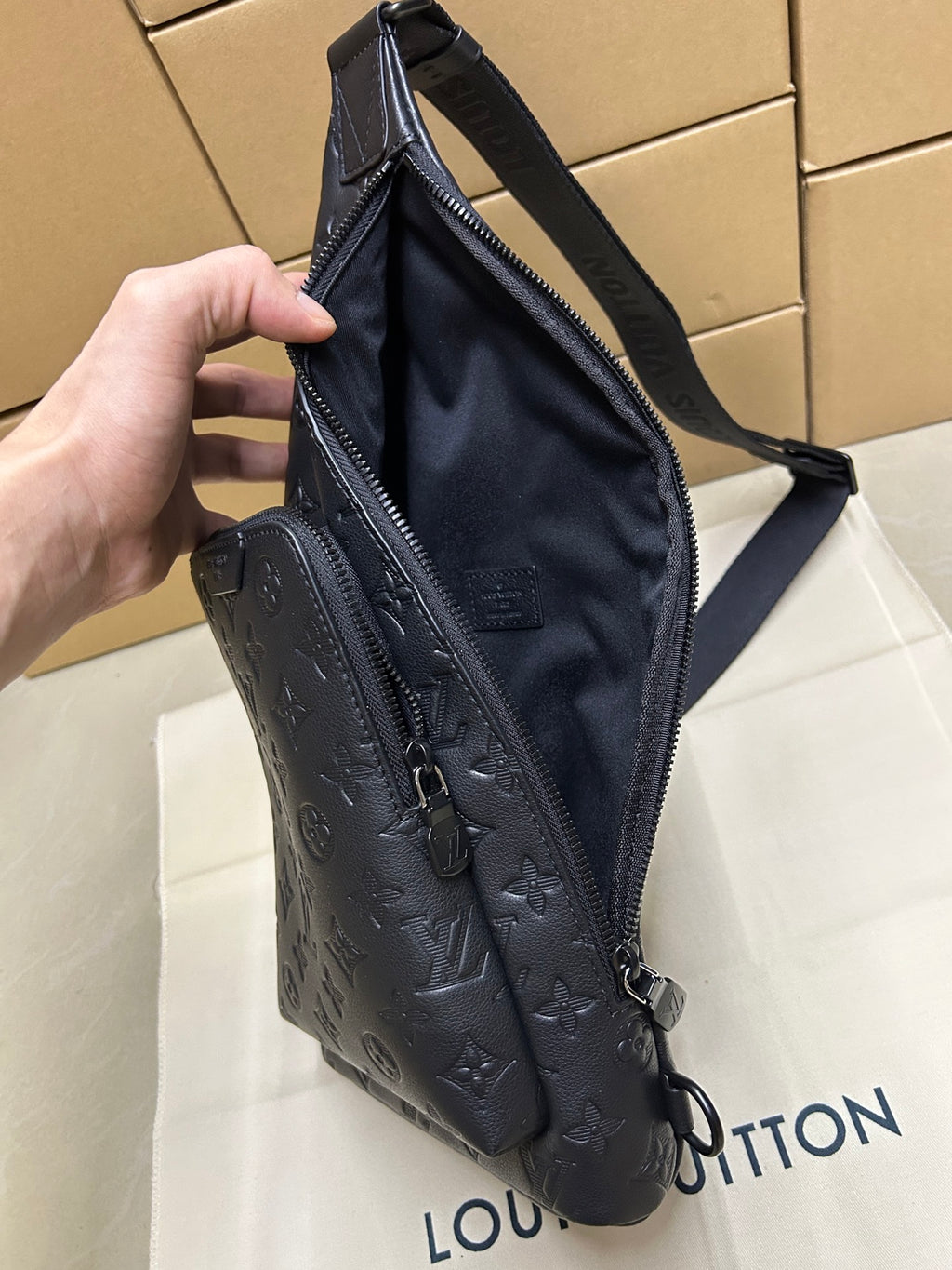 Men's Louis Vuitton monogram leather sling bag, dark blue/black, full side view with strap