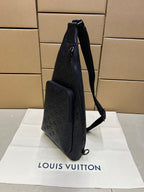 Men's Louis Vuitton monogram leather bag, dark blue/black, angled side view with shoulder strap