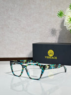 Greenish-blue rectangular eyeglasses with clear lenses and VERSACE logo on temple arms