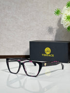Black eyeglasses with pink patterned temple details, clear lenses, VERSACE logo
