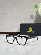 Black rectangular eyeglasses with clear lenses and VERSACE logo on temple arms